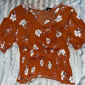 Orange floral blouse w/ navy blue and white flowers